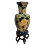 Majolica vase decorated with sunflowers on a blue background. H cm 65. With wooden base h 85 cm