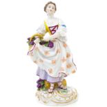 Meissen porcelain figurine depicting a woman with basket of grapes. Early twentieth century. H cm