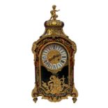 Clock Boulle style veneer, late nineteenth century. Applications in gilded brass, enamel dial with