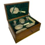 Toiletry set in silver 800. In an elegant wooden box. It consists of 8 pieces: 3 brush, 1 mirror,