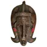 African mask with copper and fabric decorations. Cm 34x18,5.