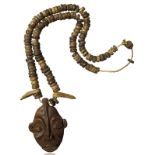 Wooden necklace with an amulet. Zaire, the twentieth century, amulet cm 6x4,5x1,5.