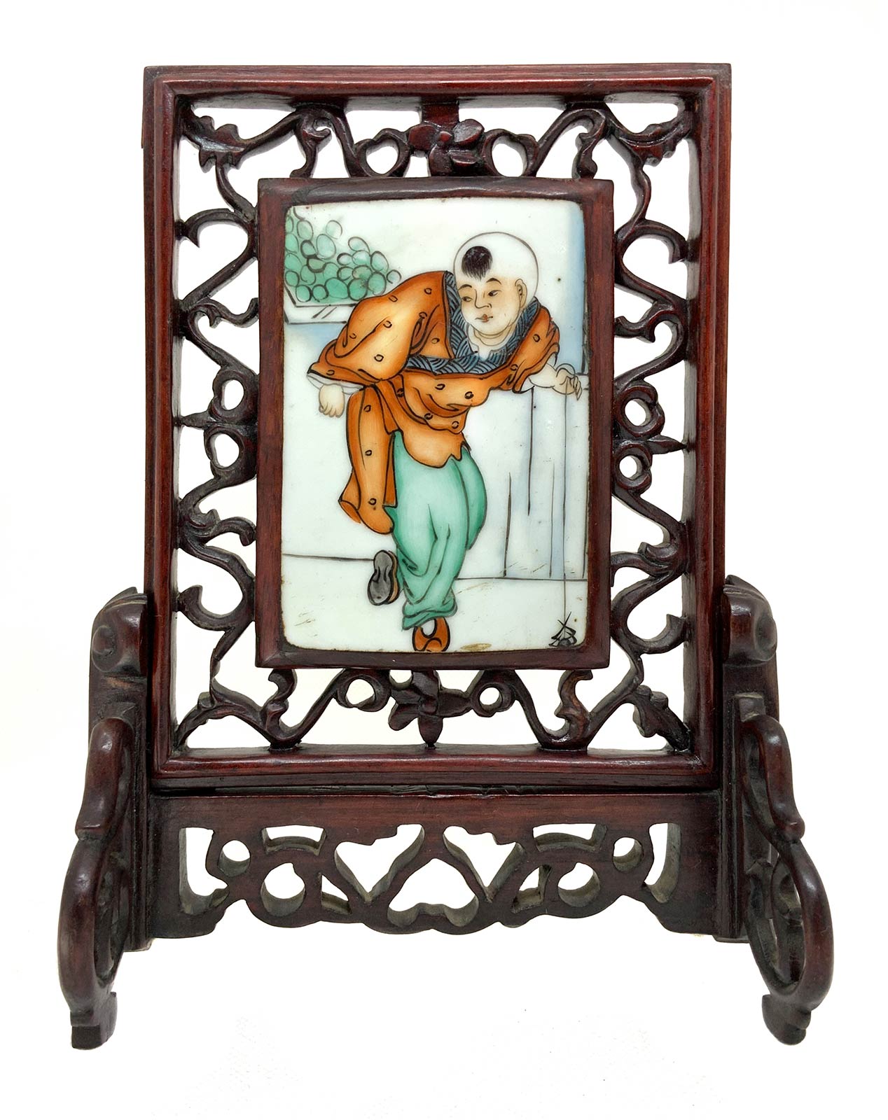 Chinese porcelain plaque depicting children, China, eighteenth century. Set in a carved wooden