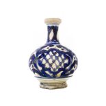 Bottle form Caltagirone, XVIII Century. Bottom of white enamel with broad leaves blue decorations.