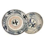 Chinese two saucers decorated in blue on a white background; one of which with a raw ring bottom