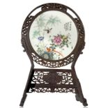 Circular chinese porcelain plate depicting bamboo, birds, and peony flower, a symbol of good luck