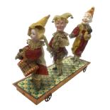 Antique toy, with three musical figures, late 19th century. Wooden head, feet and hands, clothes in