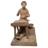 Terracotta figurine depicting monochrome cobbler at work, twentieth century, Caltagirone. H 26 cm,