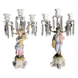 Pair of porcelain candlesticks "Biscuit" with three lights, glass toasts, Old France, XIX century.