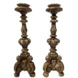 Pair of wooden candlesticks partially gilded, 19th century. H 46 cm.