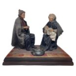 Statuette group of two elderly people and baby. Popular sicilians characters in fabric clothes.