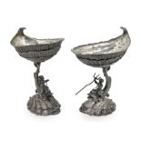 n. 2 silver sauce boats with triton and cherub. H cm 16x8x6,5. 10x8 cm Cup Gr. 302 each.