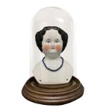 Porcelain bust depicting a child with necklace, in wooden display case, 20th century. Teca 23. H cm
