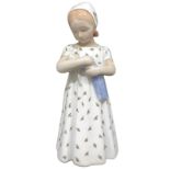 Figurine depicting a child with white dress and doll Manufactory Royal Copenhagen. H 20 cm