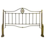 Brass bed from the nineteenth century, with porcelain medallion on headboard and footboard, glass