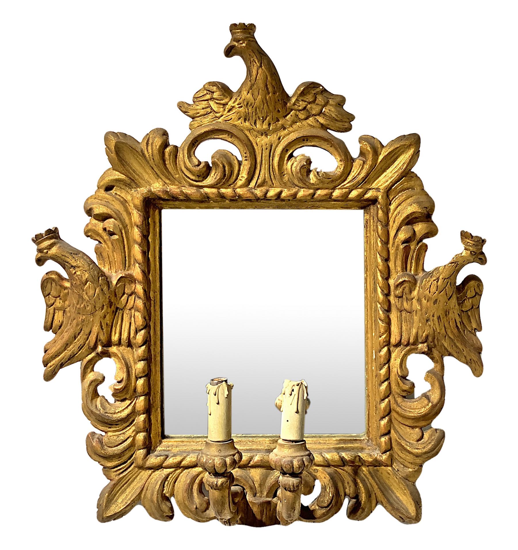 Mirror in gilded wood with two candles. 18th/19th century. Sculpted and engraved with crowned