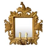 Mirror in gilded wood with two candles. 18th/19th century. Sculpted and engraved with crowned