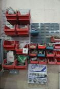 A Quantity of Spare Parts in Various Storage Bins Mounted on 2 Wall Boards