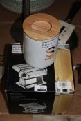 Assorted Items To Include Kitchen Roll Holder, Pasta Roller Machine, Sauce Pan & Storage Canister