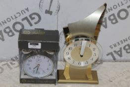 Lot To Contain 2 Assorted Designer Clocks To Inlcude An AMS Golden Award Mantle Clock And An Actim P