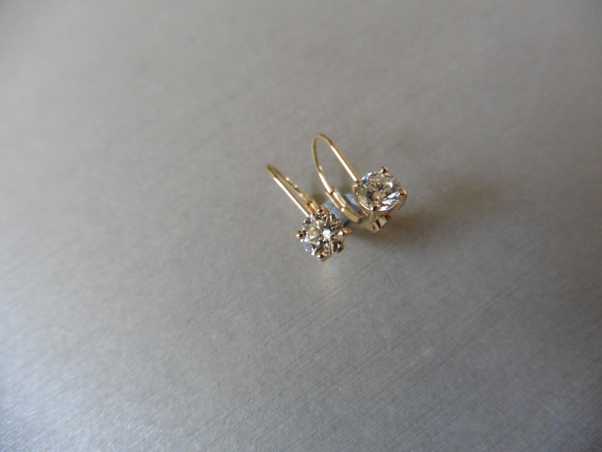 0.60ct diamond hinged style earrings each set with a brilliant cut diamond