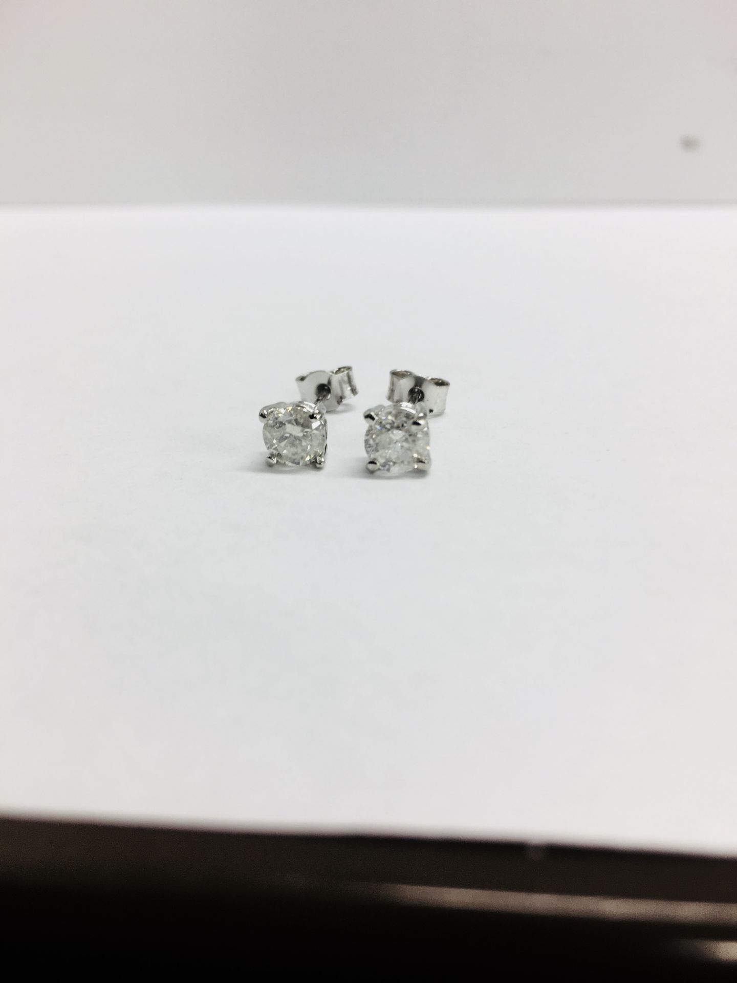 0.90ct Solitaire diamond stud earrings set with brilliant cut diamonds.