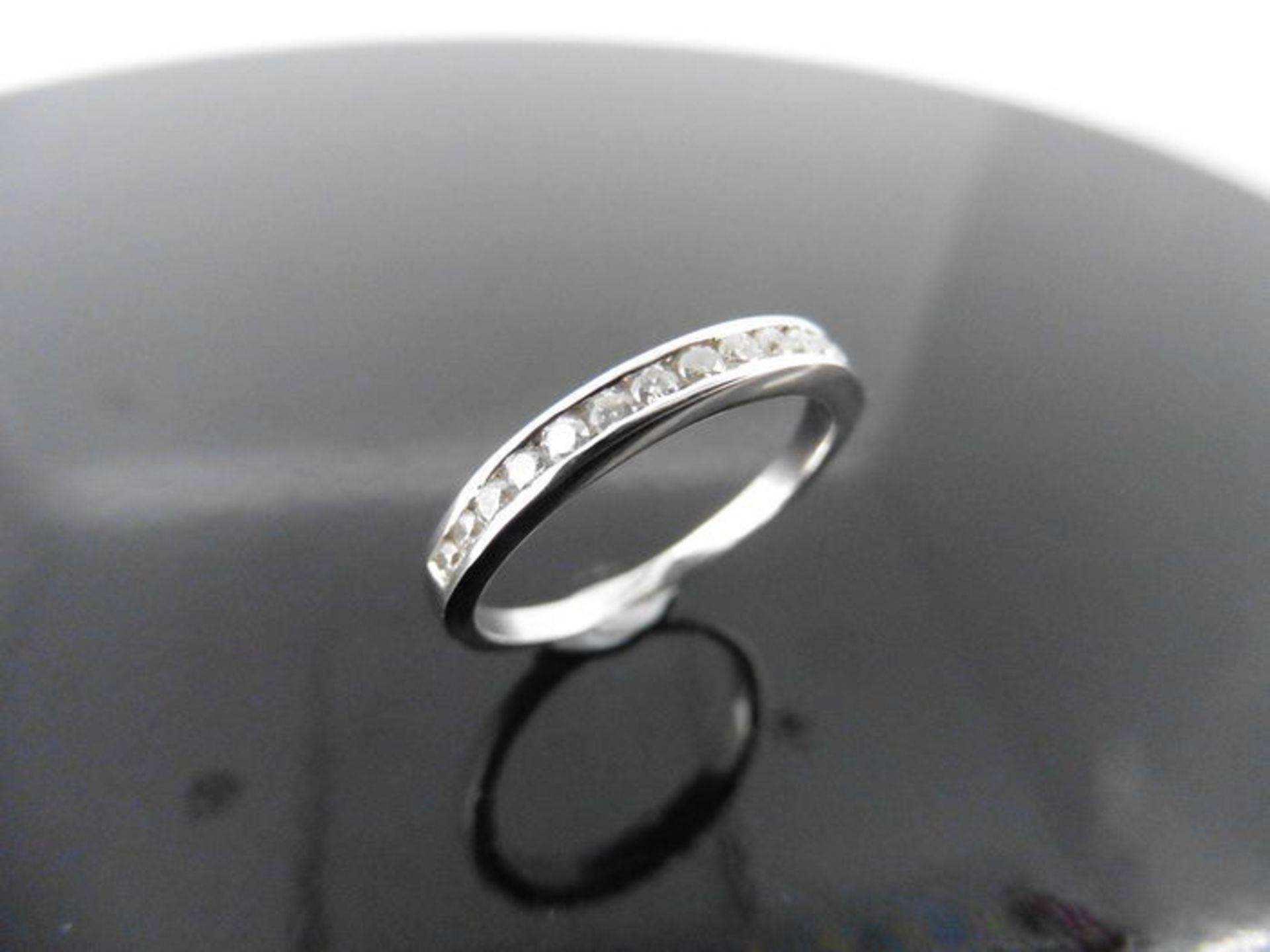 0.15ct diamond eternity ring set in 9ct white gold. Channel setting