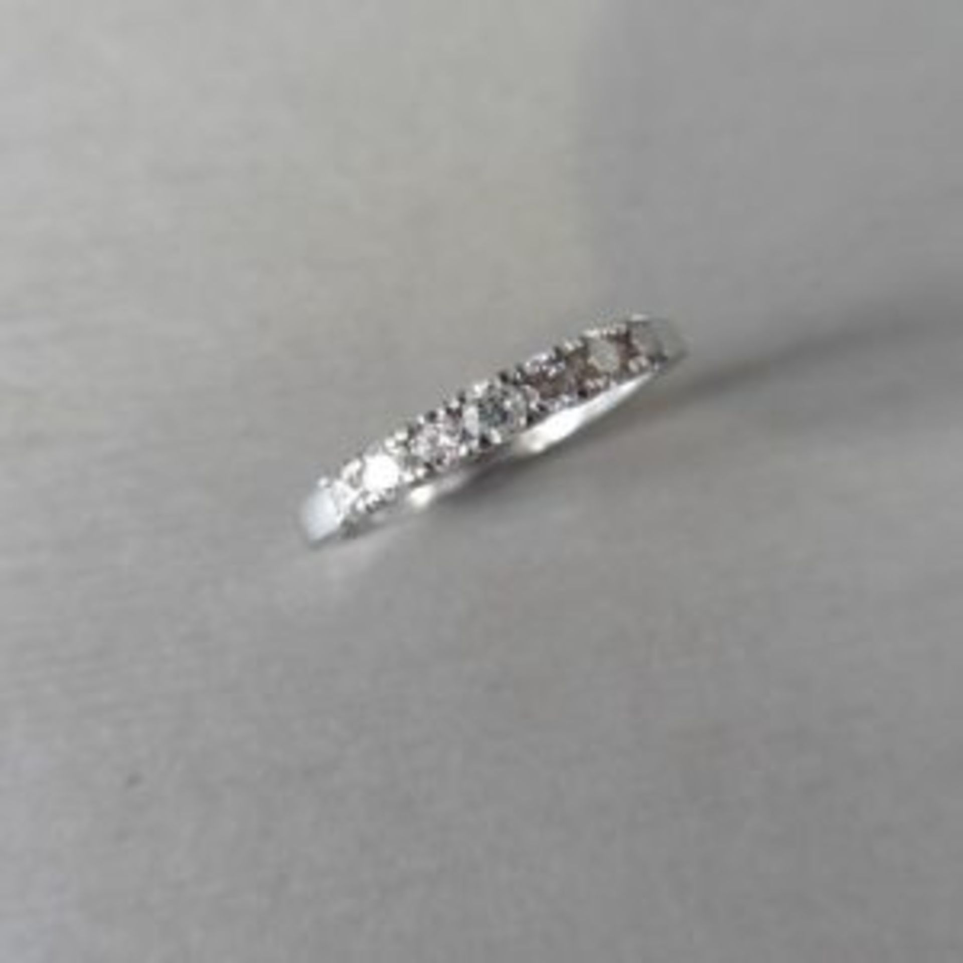 0.43ct diamond band ring. 7 brilliant cut diamonds