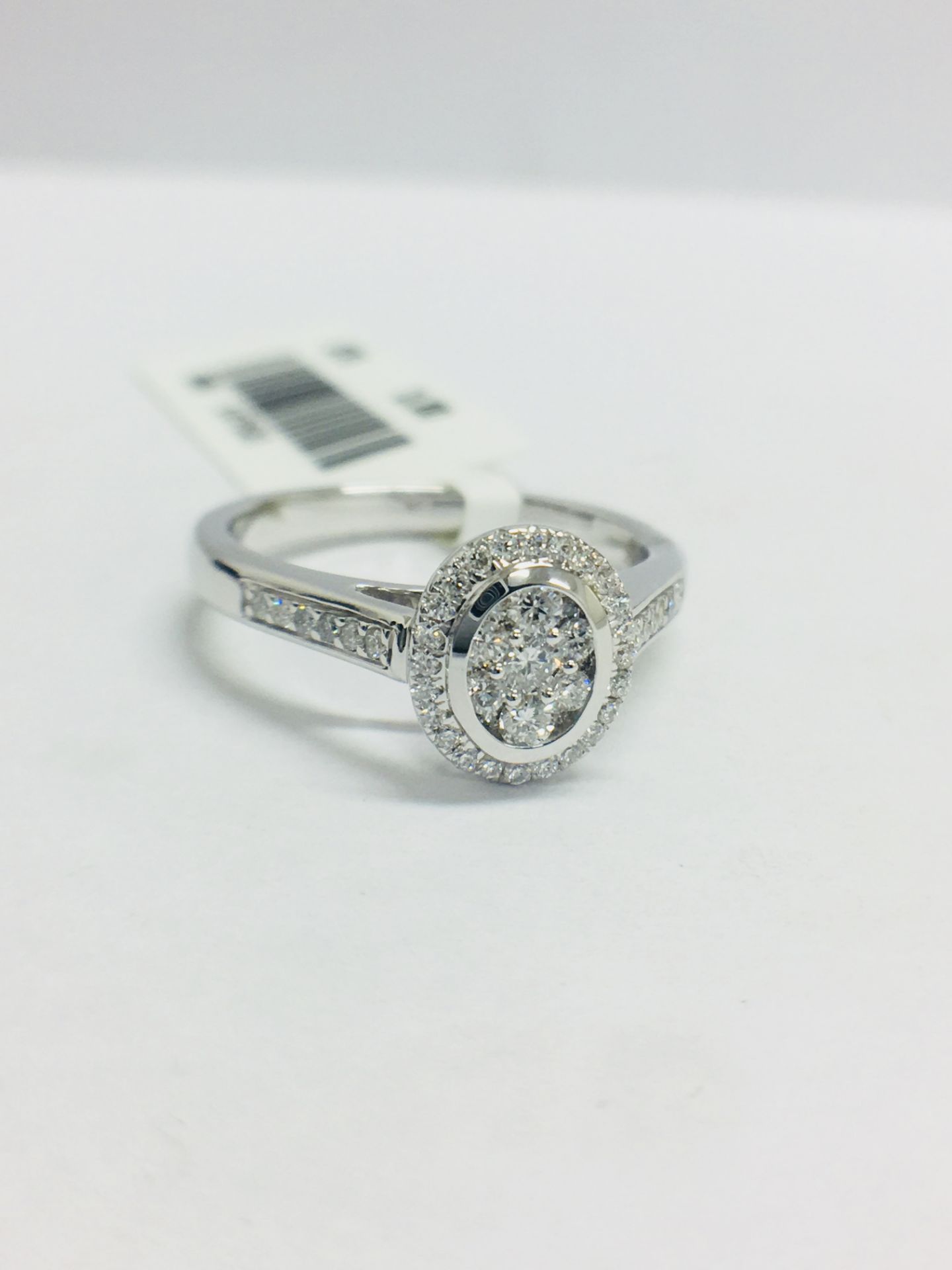 0.33ct diamond set solitaire style ring. Oval setting with small round cut diamonds