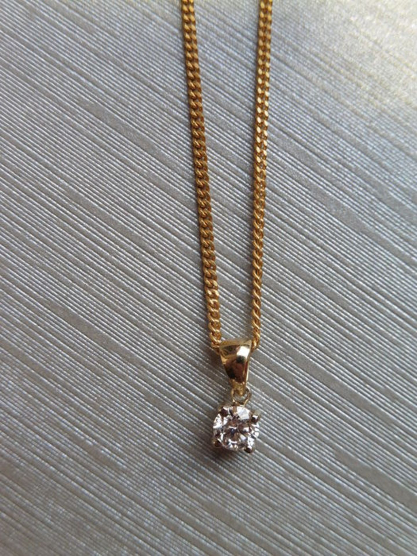 0.15ct diamond solitaire pendant set in 18ct gold. Brilliant cut diamond