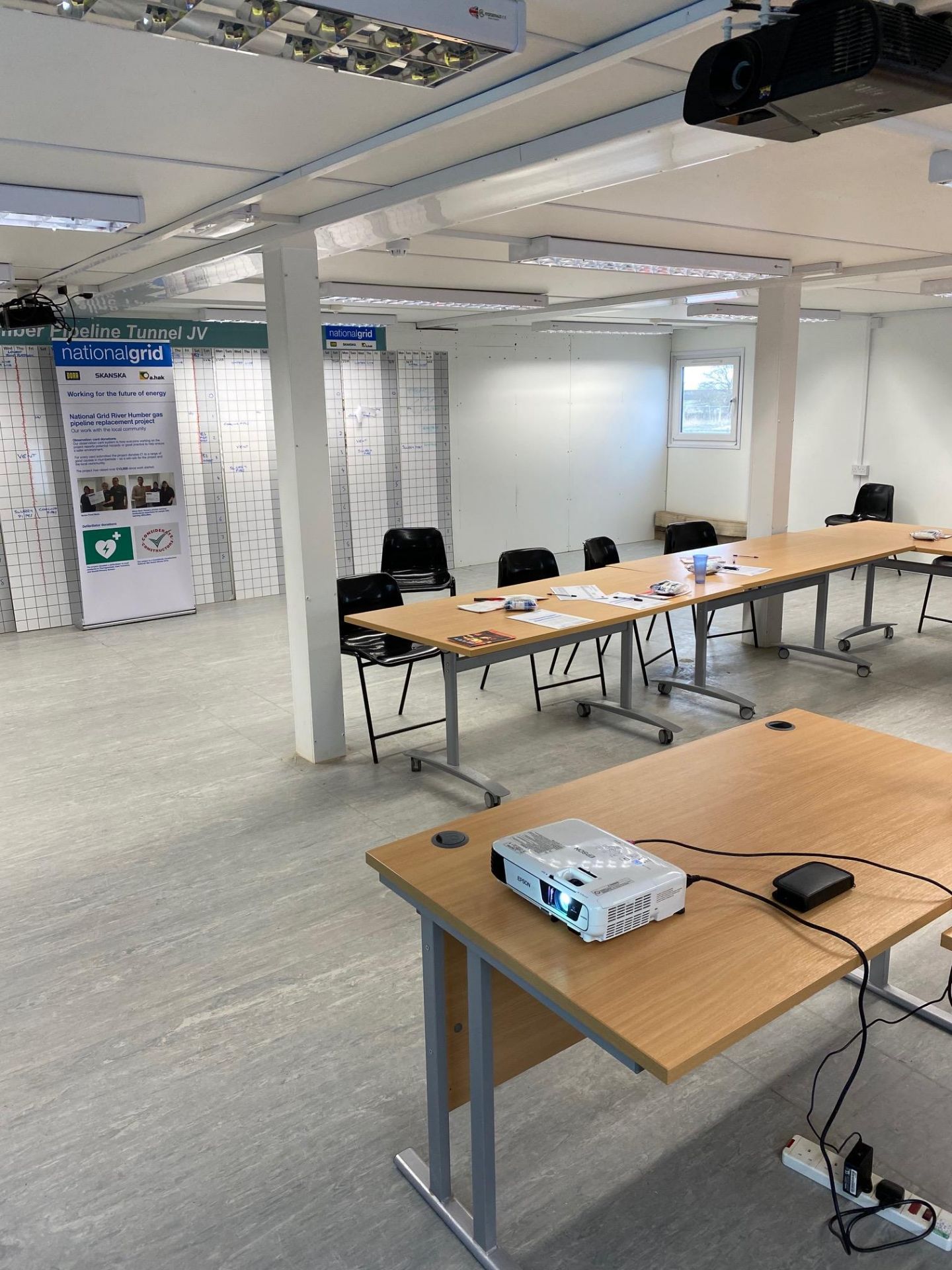 Training Building 2x Light Oak Veneered Desks; 4x Light Grey Double Door Cupboards; 7x Folding