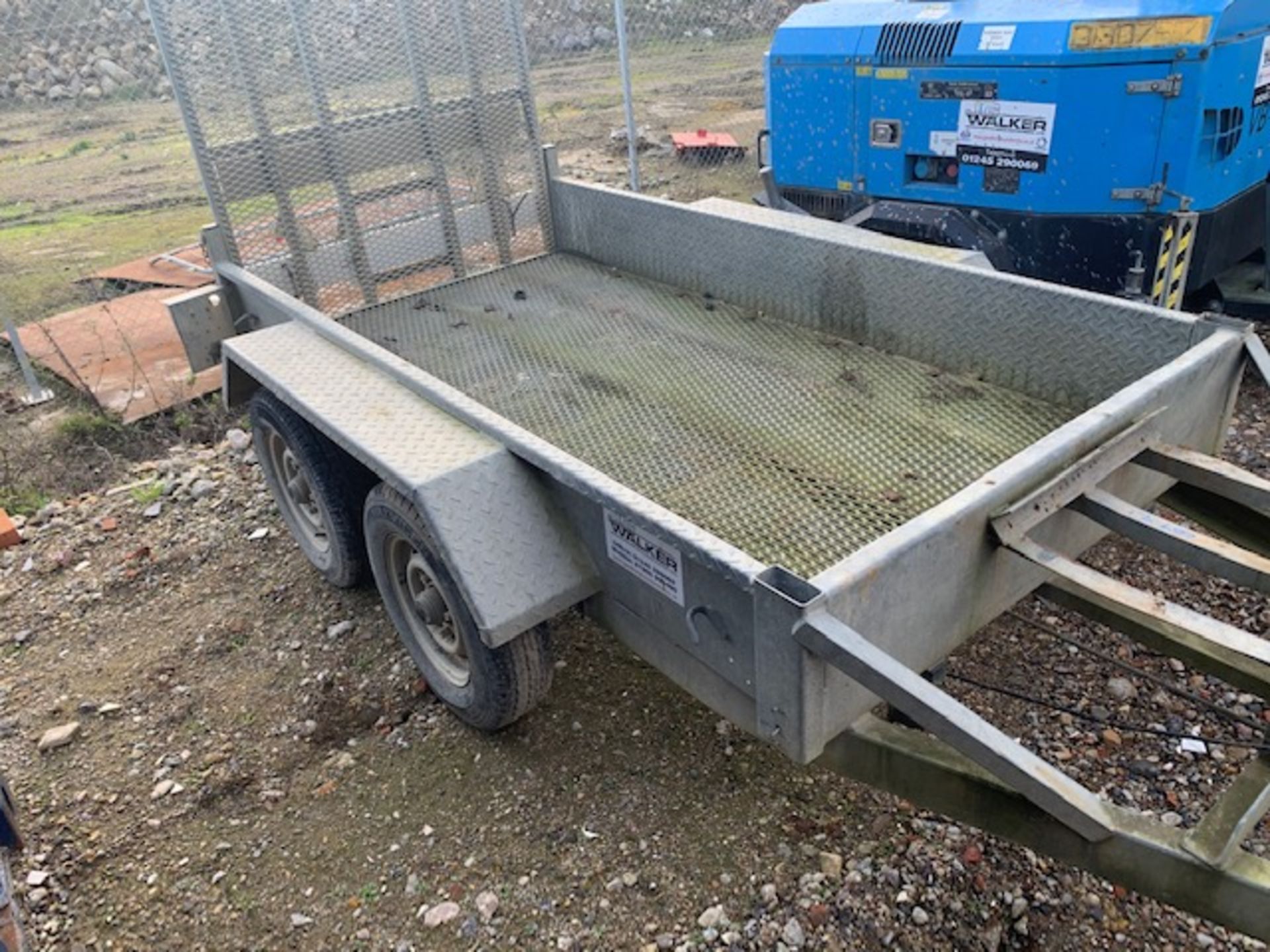 Unnamed twin axle towing trailer with built in loading ramp