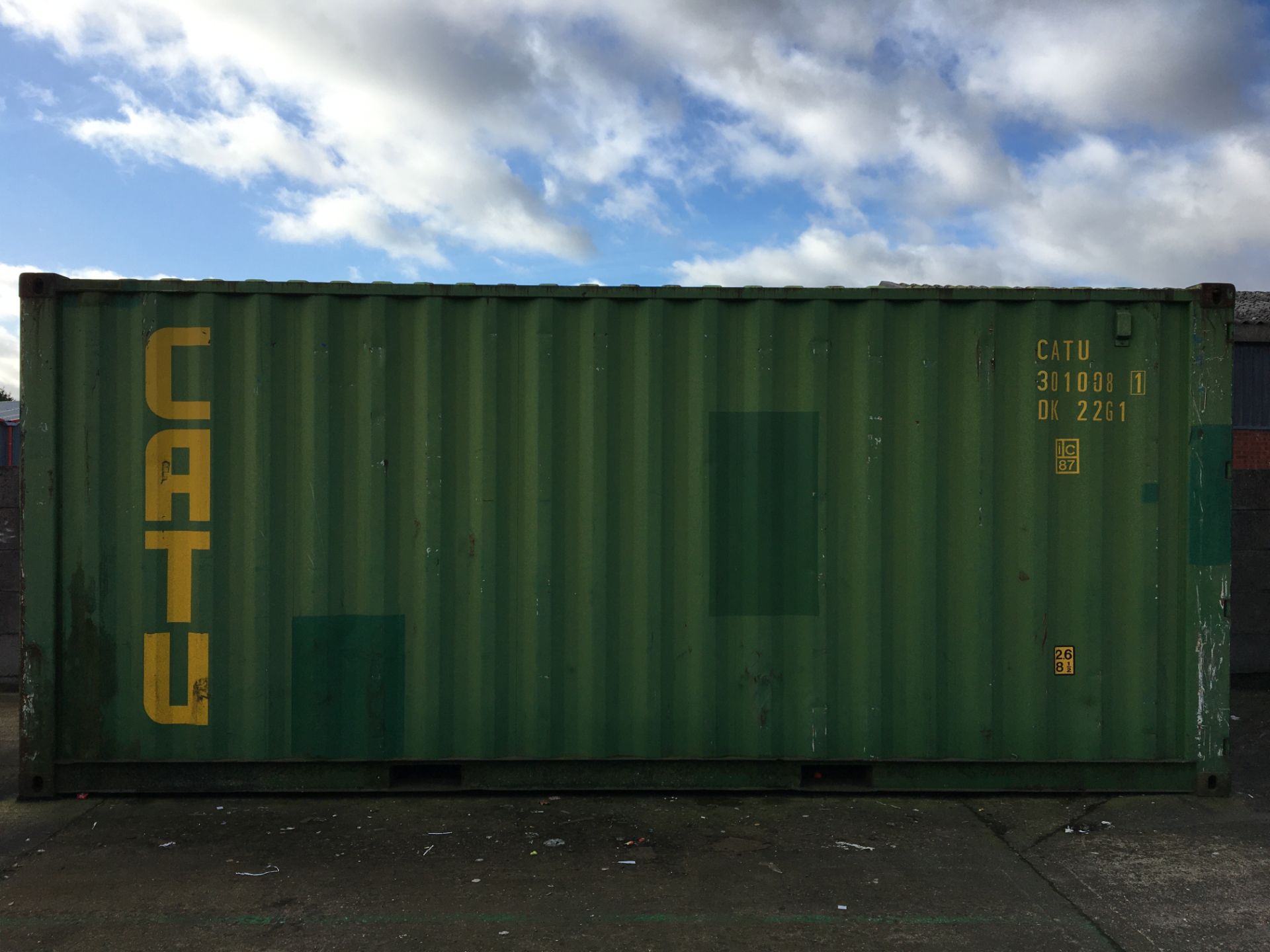 Steel 20' shipping container with rear pedestrian door comprising a bay of lightweight racking and