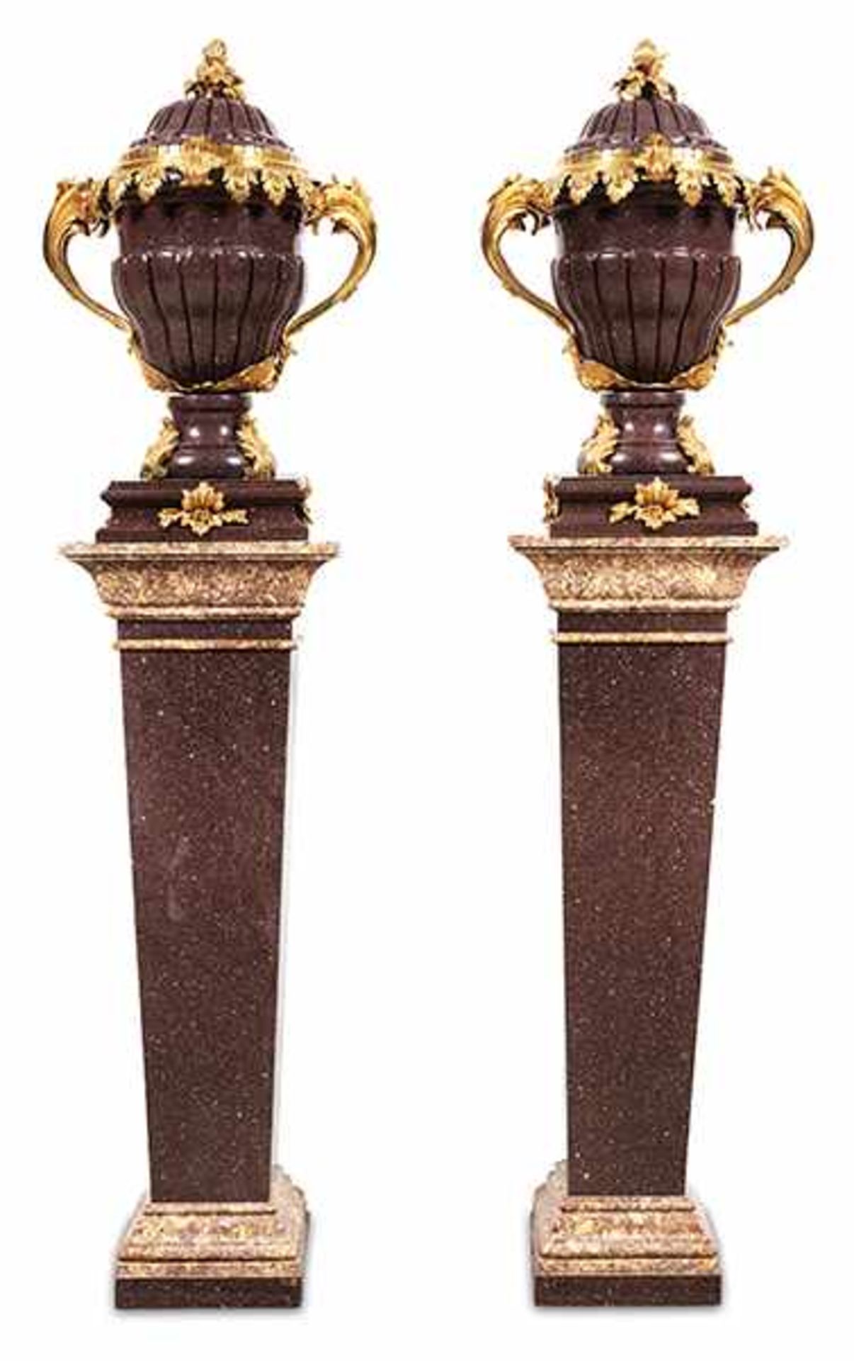 A pair of porphyry vases on pedestals