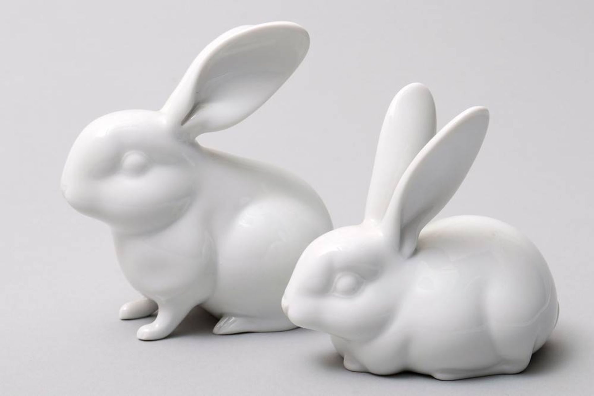 2 rabbits KPM Berlin, 20th C., glazed porcelain, 1 seated and 1 reclining rabbit, sceptre mark, H