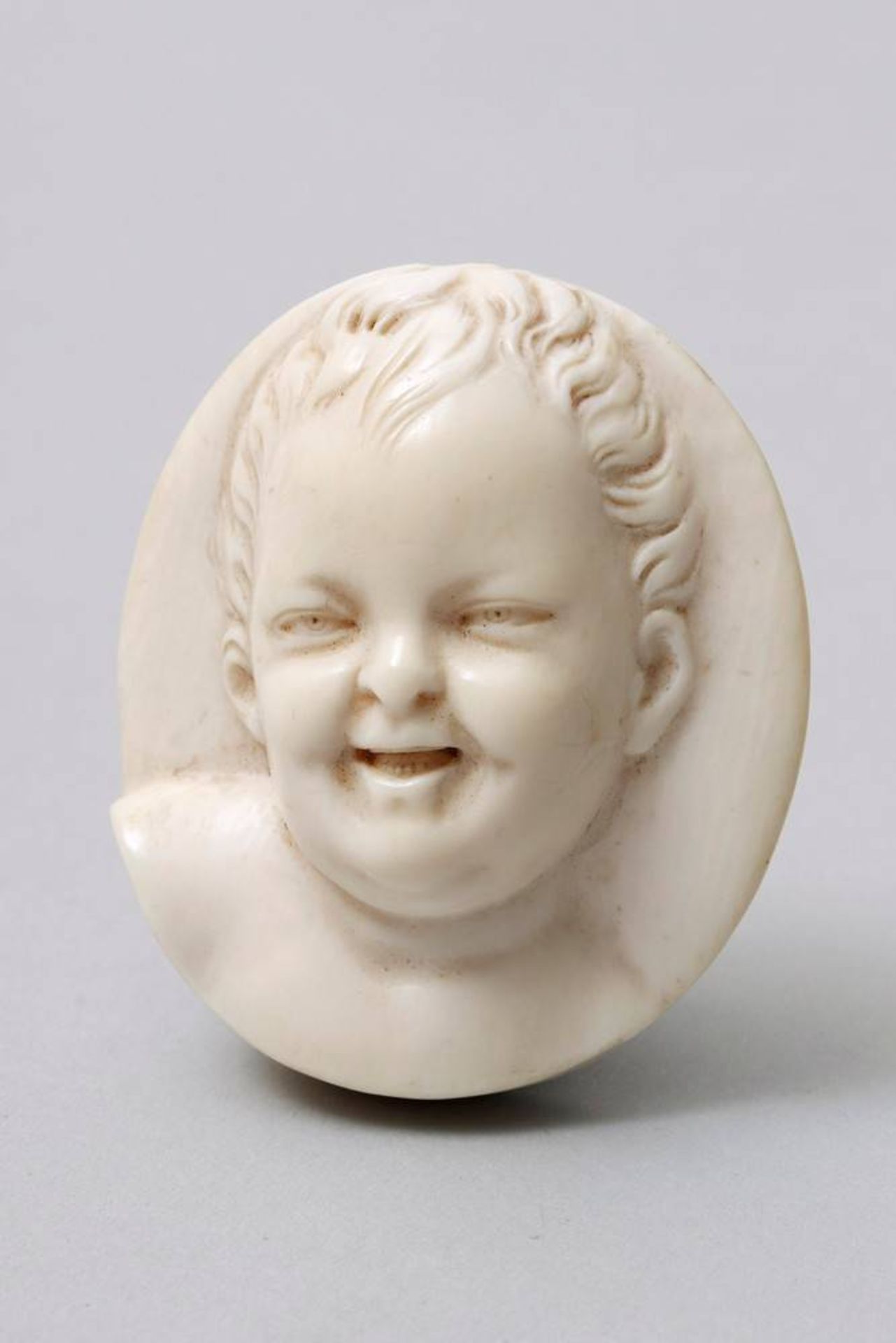 Portrait relief ivory, poss. german, 19th/20th C., smiling boy, HxB: 5x4,5cm, slight signs of age
