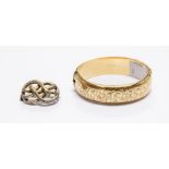 A rolled gold hinged bangle with engraving, along with a Victorian white metal lovers knot brooch (