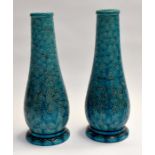 A pair of Burmantofts Faience baluster shaped turquoise vases, the bodies with abstract design