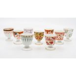 A collection of nine Victorian Crown and Royal Crown Derby egg cups, various patterns including