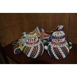 A collection of Tribal beaded items including necklaces, pipe, pots etc
