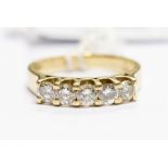 A five stone diamond 18ct gold set ring, comprising five brilliant cut diamonds, total diamond