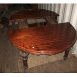 A Victorian mahogany extending D-shaped end dining table with three extra leaves, circa 1870, raised