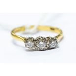 An 18ct gold and white metal three stone diamond ring, approx 0.35ct, size P, total gross weight