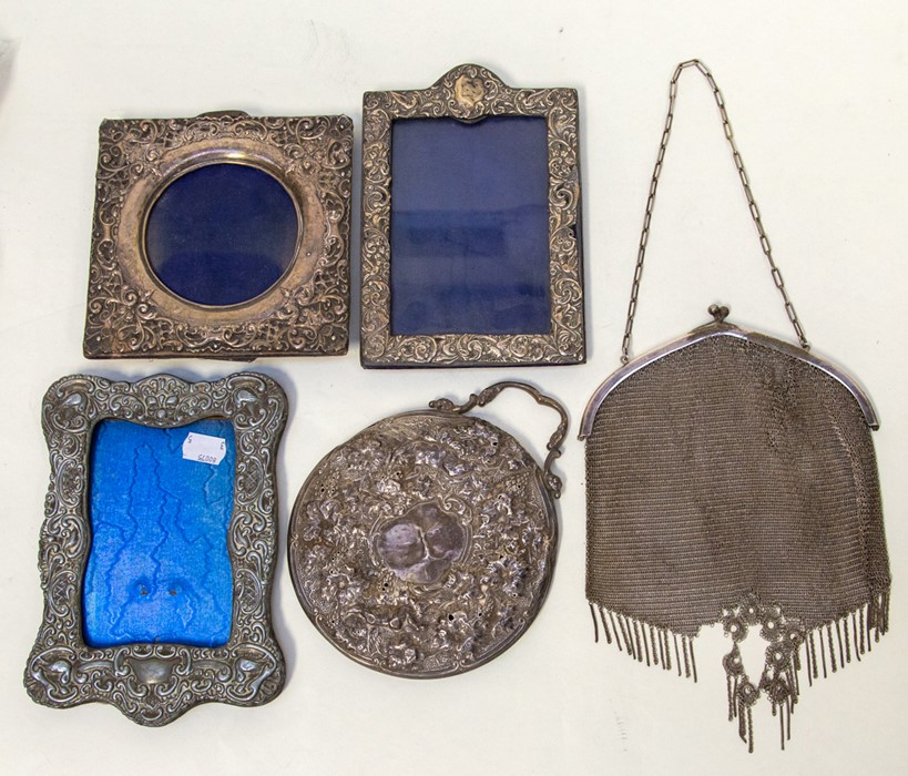 Three dated photo frames, a mirror with no glass, and a 1920's chainmail purse/evening bag