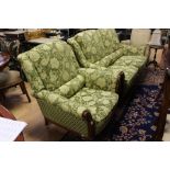 A 20th Century two seater sofa and armchair upholstered in green fabric.