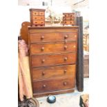 A Victorian oak chest of drawers with five graduated drawers.