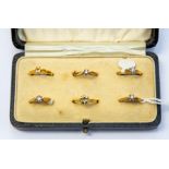 Six  unmarked yellow metal rings, four set with white paste and two yellow metal ring mounts,