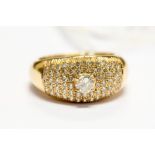 A yellow gold diamond dress ring, raised claw-set brilliant-cut to the centre approx 0.33ct, further