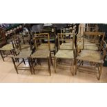 A collection of eight 19/20th century elm/oak rush seated farmhouse dining chairs (8)