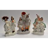 A collection of three Staffordshire flatbacks, all figural, in groups of two. (3)
